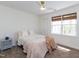 Neutral bedroom with a ceiling fan, carpet, a bed, a window, and a lamp at 2067 White Pond Ct, Apex, NC 27523