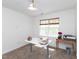 Bright bedroom with a ceiling fan and large windows, furnished with a desk and storage cart at 2067 White Pond Ct, Apex, NC 27523