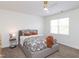 Cozy bedroom with a comfortable bed, neutral decor, and a ceiling fan at 2067 White Pond Ct, Apex, NC 27523