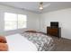 Bedroom featuring a dresser, TV, neutral paint and carpet, and a ceiling fan at 2067 White Pond Ct, Apex, NC 27523