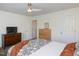 Bedroom featuring a dresser, neutral paint and carpet, ceiling fan and a large door at 2067 White Pond Ct, Apex, NC 27523