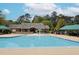An inviting community pool featuring a clubhouse, seating, and a playful fountain at 2067 White Pond Ct, Apex, NC 27523