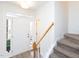 Well-lit entryway with a white front door, wood accents, and a carpeted staircase at 2067 White Pond Ct, Apex, NC 27523