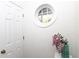 Charming interior hallway with unique round window and elegant floral arrangement at 2067 White Pond Ct, Apex, NC 27523