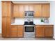 This kitchen boasts plentiful wood cabinets, stainless steel appliances, and modern finishes at 2067 White Pond Ct, Apex, NC 27523
