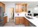 Well-lit kitchen featuring white countertops, wooden cabinets, and stainless steel appliances at 2067 White Pond Ct, Apex, NC 27523