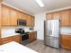 Bright kitchen features stainless steel appliances, white countertops, and light wood cabinets at 2067 White Pond Ct, Apex, NC 27523