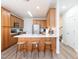 An open kitchen flows seamlessly with stainless steel appliances, counter seating, and bright lighting at 2067 White Pond Ct, Apex, NC 27523