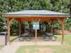 Community park pavilion area featuring picnic tables and trash receptacles for resident's enjoyment at 2067 White Pond Ct, Apex, NC 27523