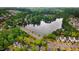 Beautiful aerial view of a community surrounding a lake with lush green trees and well-maintained homes at 2120 Castle Pines Dr, Raleigh, NC 27604