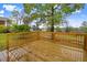 Backyard wood deck overlooking yard with mature trees and landscape at 2120 Castle Pines Dr, Raleigh, NC 27604