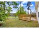 Wood deck in a grassy backyard with trees surrounding the property at 2120 Castle Pines Dr, Raleigh, NC 27604