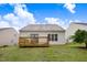 Back exterior featuring a wood deck, flat grassy area, and the home's siding at 2120 Castle Pines Dr, Raleigh, NC 27604