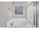 Relaxing bathroom with a soaking tub, glass-enclosed shower, and a privacy window at 2120 Castle Pines Dr, Raleigh, NC 27604