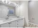 Bathroom features a double sink vanity, updated lighting, and modern fixtures at 2120 Castle Pines Dr, Raleigh, NC 27604