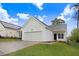 Charming one-story home featuring white siding, a spacious garage, and a well-manicured lawn at 2120 Castle Pines Dr, Raleigh, NC 27604
