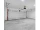 A two car garage with automatic door, concrete floors, and painted drywall at 2120 Castle Pines Dr, Raleigh, NC 27604