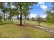 Picturesque view of the grassy golf course and mature trees on a beautiful, sunny day at 2120 Castle Pines Dr, Raleigh, NC 27604