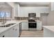 Modern kitchen with white cabinets, stainless steel appliances, and ample counter space at 2120 Castle Pines Dr, Raleigh, NC 27604