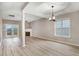 Bright, open living room featuring hardwood floors, a fireplace, and French doors at 2120 Castle Pines Dr, Raleigh, NC 27604