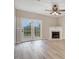 Bright living room with hardwood floors, a fireplace, and French doors leading to outdoor space at 2120 Castle Pines Dr, Raleigh, NC 27604