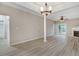 Spacious living room with a fireplace, hardwood floors, modern lighting, and French doors to the exterior at 2120 Castle Pines Dr, Raleigh, NC 27604