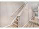 Carpeted staircase with white railings leads to the home's upper level at 2120 Castle Pines Dr, Raleigh, NC 27604