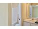 Bright bathroom featuring shower-tub combo, toilet, and vanity with sink, with large mirror, neutral tones at , Raleigh, NC 27604