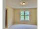 Bright, carpeted bedroom with a large window providing natural light and pleasant views at , Raleigh, NC 27604