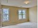 Carpeted bedroom featuring two bright, shuttered windows offering exterior views and ample natural light at , Raleigh, NC 27604