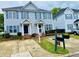 Charming townhome featuring a well-maintained lawn and a symmetrical facade with blue shutters at , Raleigh, NC 27604