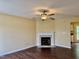 Inviting living room with a classic fireplace, ceiling fan, and hardwood floors at , Raleigh, NC 27604