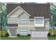 Charming two-story home showcasing a well-manicured lawn and a welcoming entrance, complemented by lush landscaping at 230 N Maple Walk Dr # 230, Garner, NC 27529