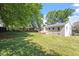 Expansive backyard featuring lush green space and trees, ideal for outdoor activities at 2304 Nelson St, Raleigh, NC 27610