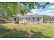 Backyard view of the house with lush greenery and a wooden deck at 2304 Nelson St, Raleigh, NC 27610