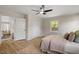 Comfortable bedroom features wood-look floors, a ceiling fan, and closet space at 2304 Nelson St, Raleigh, NC 27610
