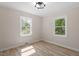 Comfortable bedroom features natural light, neutral walls, and modern light fixture at 2304 Nelson St, Raleigh, NC 27610