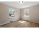 Bright bedroom with two windows, neutral walls, and light-colored flooring at 2304 Nelson St, Raleigh, NC 27610