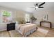 Cozy bedroom with natural light, wood-look floors, ceiling fan, and neutral decor at 2304 Nelson St, Raleigh, NC 27610