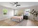 Bright bedroom features a ceiling fan, large windows and a comfortable king bed at 2304 Nelson St, Raleigh, NC 27610