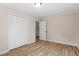 Spare bedroom with light walls, white closet, wood-look floors and natural light at 2304 Nelson St, Raleigh, NC 27610
