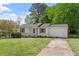 Exterior view of a beautiful white house, green grass, and blue sky at 2304 Nelson St, Raleigh, NC 27610