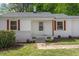 A well-maintained front entrance with a porch, steps, and mature landscaping at 2304 Nelson St, Raleigh, NC 27610
