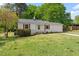 Landscaped front yard featuring mature trees and a well-maintained lawn at 2304 Nelson St, Raleigh, NC 27610