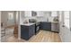 Modern kitchen with stainless steel appliances, white countertops and navy cabinets at 2304 Nelson St, Raleigh, NC 27610