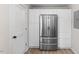 Bright kitchen featuring white cabinets and drawers, stainless-steel fridge and modern light-colored flooring at 2304 Nelson St, Raleigh, NC 27610
