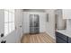 Bright kitchen features stainless steel refrigerator, white cabinets, and light-colored flooring at 2304 Nelson St, Raleigh, NC 27610