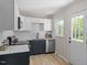 Well-lit kitchen boasts stainless steel appliances, dark-blue cabinetry, and modern countertop at 2304 Nelson St, Raleigh, NC 27610