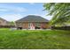 Expansive grassy backyard with a patio, mature trees, and privacy fence at 2326 Marlow Dr, Burlington, NC 27215