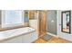 Bathroom features soaking tub, glass shower, and tiled floors at 2326 Marlow Dr, Burlington, NC 27215